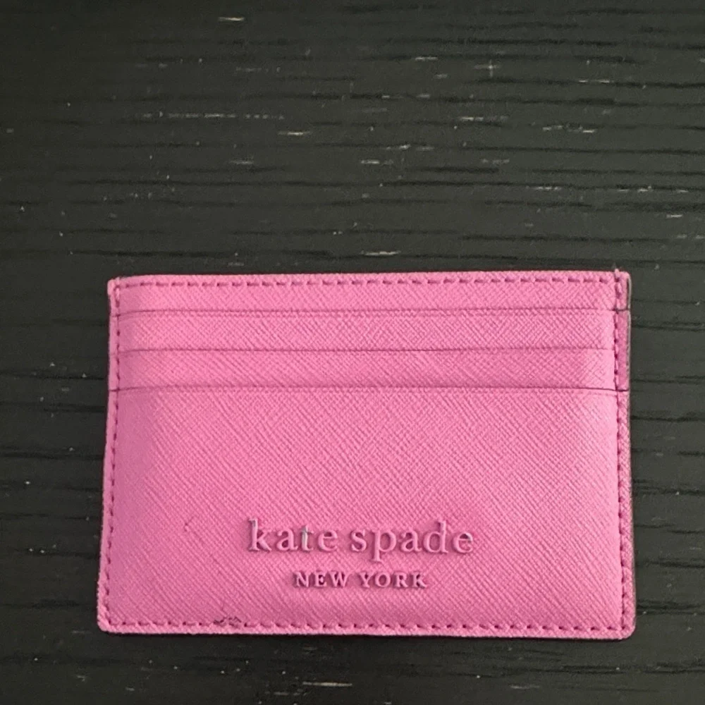 Kate spade bright pink metal logo card holder. 6-pocket; 1 center slot pocket.